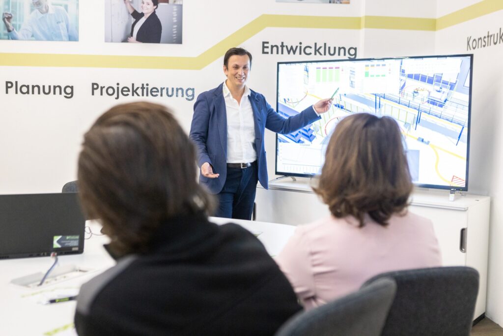 A ProLog employee conducts an AGV training course for ProLog customers in the training room.